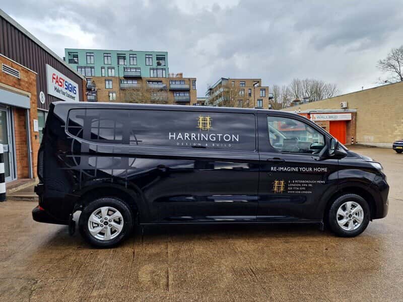 An image of a black Harrington van with vehicle graphics and wraps